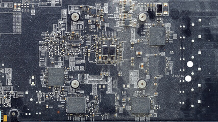 dirty printed circuit board with chips and transistors covered with a layer of dust, the cause of overheating and failure of electrical equipment, a close-up of an uncleaned motherboard.