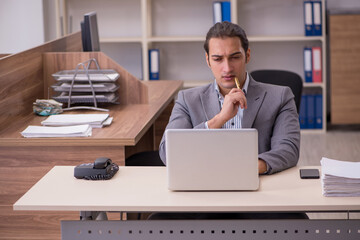 Young male employee working in the office