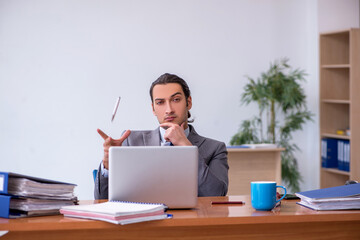 Young male employee working in the office