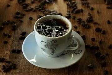 Closeup of Typical Brazilian Coffee Cup and Coffee Beans on a Wooden Table