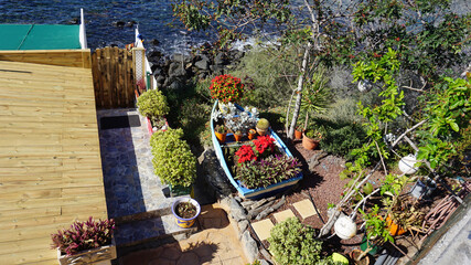 A small mediterranean garden by the sea with plenty of plants and cacti in Costa Adeje, Tenerife, Canary Islands, Spain.                            