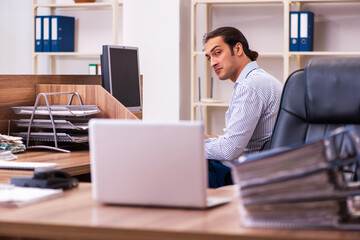 Young male employee working in the office