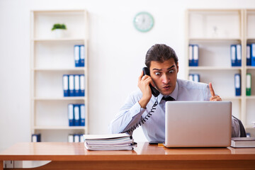 Fototapeta premium Stressed male employee working in the office