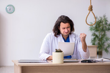 Young male doctor committing suicide in the hospital