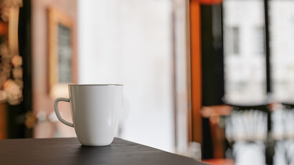 White Mug on Top Of Table in Open Coffee Shop