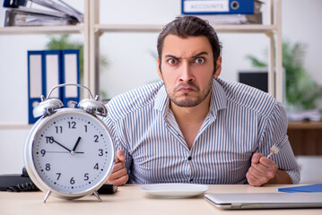 Hungry male employee waiting for food in time management concept