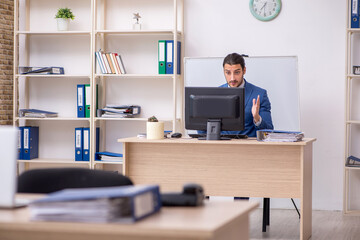 Young male businessman employee working in the office