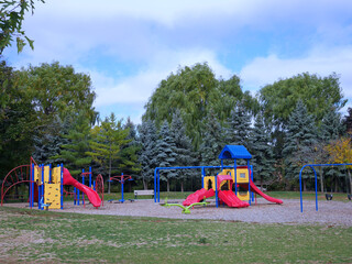 Public park with willow trees and playground equipment