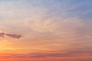 Sunrise, sunset blue orange pink gentle sky in sunlight with cirrus clouds abstract background texture