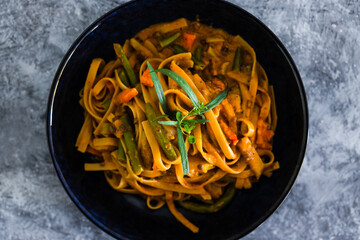 plant-based food, vegan fettuccini with mixed vegetables and creamy sauce