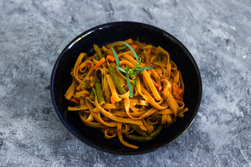 plant-based food, vegan fettuccini with mixed vegetables and creamy sauce