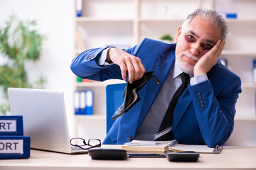 Old face injured employee sitting in the office