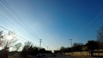 neighborhood street with open sky and power lines