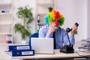 Old businessman clown working in the office
