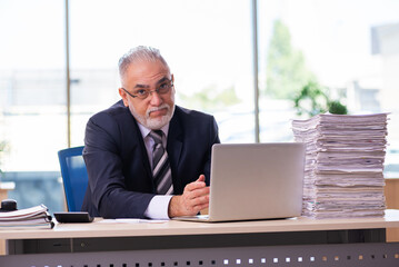 Aged businessman employee unhappy with excessive work