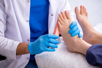 Podiatrist treating feet during procedure
