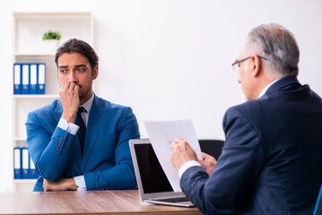 Fototapeta premium Young male candidate employee meeting with old recruiter