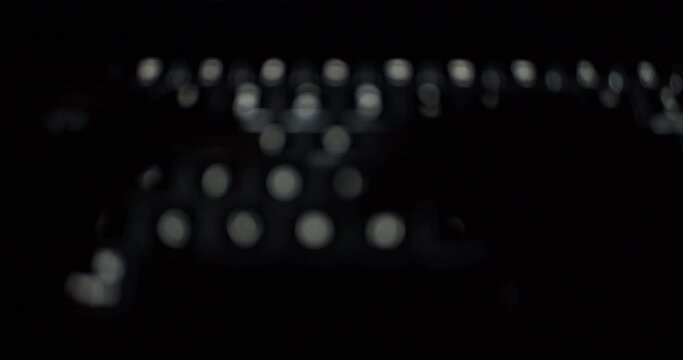 Blurry footage of hands typing on illuminated keyboard - defocused concept computer work