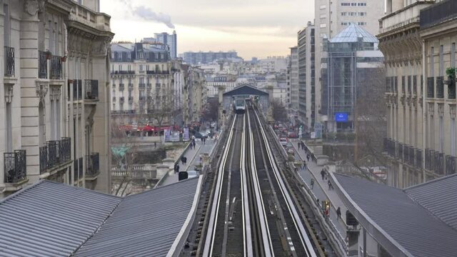 Paris, France, 31.1.2021. subway train entering station. this railway station in soft sunshine light as tourists enter and leave the busy station