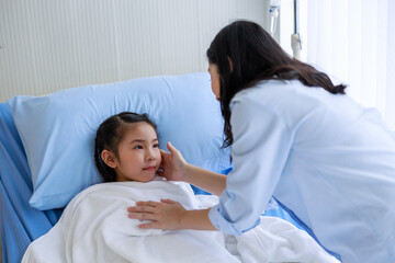 Fototapeta premium Sick girl lying on the hospital bed