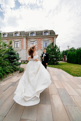 Fototapeta premium The groom and the bride walk outdoors. first meeting before the wedding ceremony