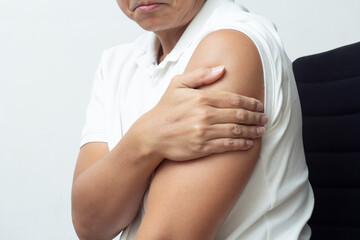 man cover his arm not to get vaccine