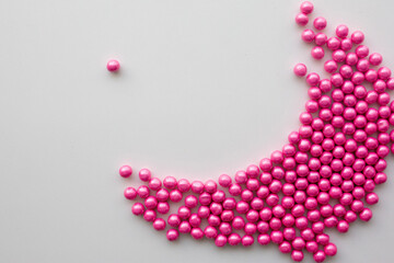 round pink candies on a white background