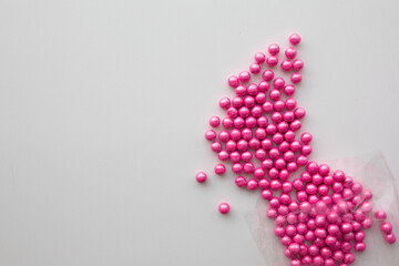 round pink candies on a white background