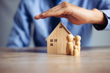 Insurance house, and family health live concept. The insurance agent presents  the ้hands...