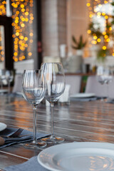 Modern veranda restaurant interior, banquet setting, glasses, plates