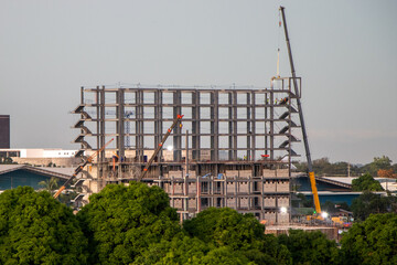 Modern city building (steel framework) under construction in Asian urban area - Angeles City, Pampanga, Philippines	