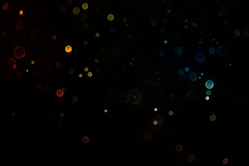 Abstract gold glitter explosion on bokeh black background