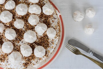 Freshly baked delicious homemade Meringue cake/ Turkish Beze or Meringue cake served on white wooden table/ Recipe