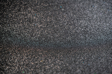 glitter vintage lights background. gold, silver, blue and black. de-focused.