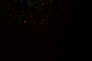 gold glitter explosion on bokeh black background