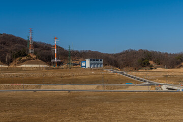 Electrical transfer substation on edge of graded field for new construction project.