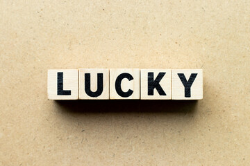 Obraz premium Letter block in word lucky on wood background