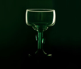 a cocktail glass with a foot in the form of a cactus against a bright background, closeup