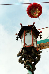 Ornate street lamp and red paper lantern decorates Chinatown, San Francisco, California 