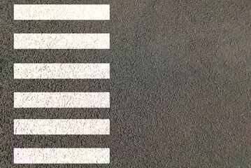Zebra crossing made of stripes white and black lines painted on road for pedestrians crossing on...