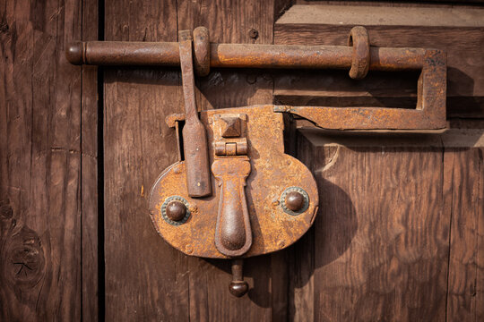 Old rusted lock on vintage wooden door