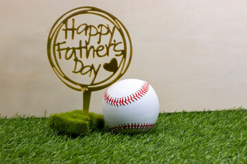 Baseball with Happy Father's Day on green grass