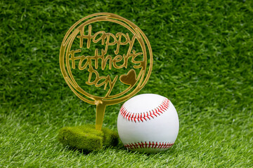 Baseball with Happy Father's Day on green grass