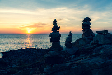 Zen concept. The object of the stones on the rock at sunset. Zen stones..