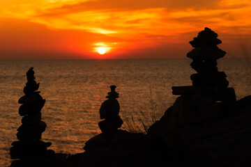 Zen concept. The object of the stones on the rock at sunset. Zen stones..