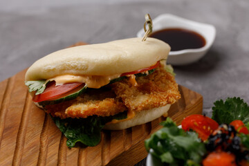 Bao buns. Hawaiian dish, on a wooden table. Pan-Asian cuisine concept. Close-up