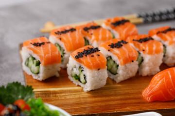 Philadelphia roll with cucumber and sushi with salmon and tuna. Sushi menu. Japanese food.