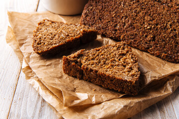 Closeup on sliced triangle flourless diet grain bread on parchment paper