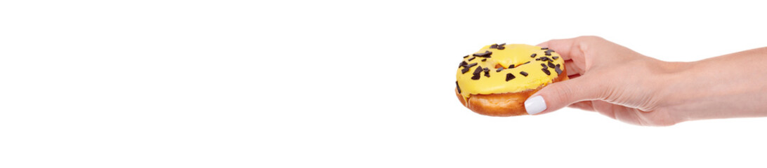 Hand with sweet donut with icing and chocolate drops, isolated on white background.