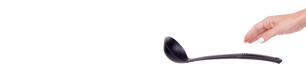 Hand with black plastic ladle, kitchen utensil, isolated on white background.